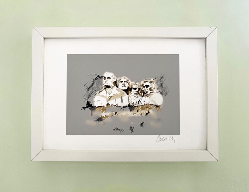 May include: A framed black and white sketch of Mount Rushmore, featuring the four presidents carved into the mountainside. The sketch is on a grey background and is signed "Cleo 21".