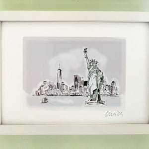 May include: A black and white sketch of the Statue of Liberty and the New York City skyline. The image is framed in a white frame and signed "Cleindy".