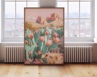 May include: A pink and green cactus print featuring a desert landscape in the background. The cactus is in bloom with pink flowers. The landscape is a soft pink colour with a mountain range in the distance.
