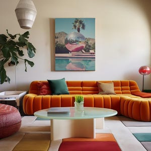 May include: A large orange sectional sofa with tufted cushions sits in a living room with a white coffee table and a green plant. A painting of a palm tree and a pool hangs on the wall.