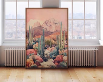 May include: A framed print depicting a desert landscape with a pink sky and mountains in the background. The foreground features a variety of cacti and colourful rocks.