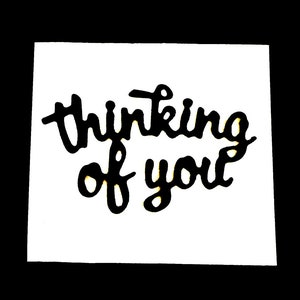 May include: A white square with the phrase "thinking of you" in black cursive script. The text is centered on the square, which is set against a solid black background. The overall design is simple and elegant.