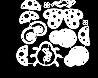 May include: A white metal die-cut stencil featuring a collection of various shapes including a central beetle, a butterfly, several semi-circles, and circular forms, all decorated with small cut-out holes, connected by thin metal bridges.