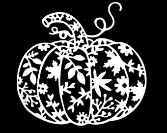 May include: White, intricately cut-out pumpkin silhouette against a black background. The pumpkin is filled with floral and leaf patterns, including flowers, leaves, and vines. The stem and a curly tendril are also visible.