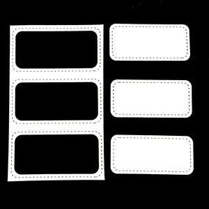 May include: A sheet of white rectangular labels with rounded corners and a dotted border. Three labels have black interiors, while the other three are blank. The labels are on a black background.