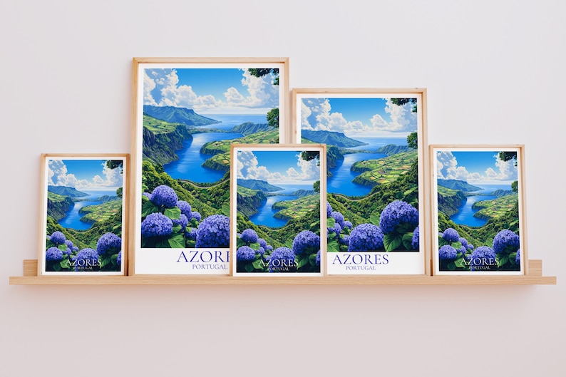 May include: Five framed art prints featuring a scenic landscape of the Azores, Portugal. The artwork depicts a blue river winding through green hills, with vibrant blue hydrangeas in the foreground. Each print is in a wooden frame.
