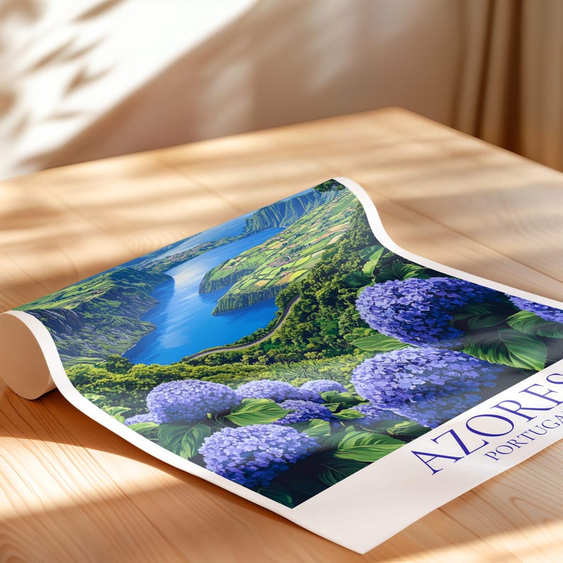 May include: A rolled-up poster featuring a scenic view of the Azores, Portugal. The artwork depicts a vibrant landscape with a blue lake, green hills, and purple hydrangeas. The poster has the word "AZORES" in navy blue.
