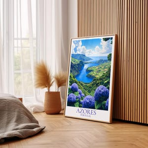 May include: A framed print featuring a scenic view of the Azores, Portugal, with a vibrant blue lake and lush green hills. The print is accented by large, purple hydrangea flowers in the foreground. The text "Azores Portugal" is printed at the bottom.