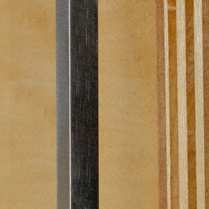 May include: A silver metal door handle with two screws. The handle is attached to a wooden door.