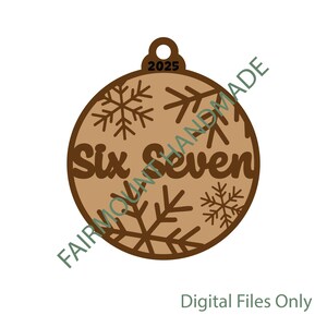 May include: A round, wooden Christmas ornament with the words "Six Seven" cut out. The ornament has snowflake cutouts and the year "2025" at the top. The words "FAIRMOUNTAINHANDMADE" are printed on the side. The words "Digital Files Only" are at the bottom.