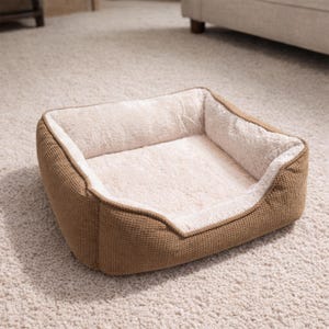 May include: A rectangular pet bed with a brown woven exterior and a soft, cream-colored interior. The bed has a low front and raised sides for comfort and security. Ideal for small dogs or cats.