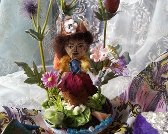Handmade little fairy made from flowers, mounted on a decorative base and surrounded by pretty flowers, about 6" tall, very cute!