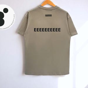 Camiseta masculina de algodão com estampa gráfica | Estampa de letras flocadas na frente e atrás | Camisa de manga curta macia | Blusa casual de rua | Estilo urbano moderno