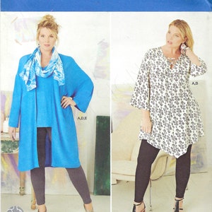 May include: Simplicity sewing pattern featuring plus-size women's clothing designs. The pattern includes options for a tunic, leggings, and a long cardigan. The image shows two women modeling the clothing. The pattern size is U.S. 18W-24W.