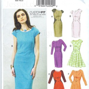 May include: A sewing pattern envelope for Vogue Patterns V8902 featuring a blue cap-sleeve sheath dress on the front. The envelope displays six variations of the dress design labeled A through F, showcasing different sleeve lengths, skirt shapes, and fabric patterns.