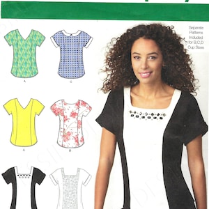 May include: Simplicity sewing pattern 1316 featuring various women's top designs. The pattern includes sizes 14-22 and is designed and printed in the USA. The image shows a woman wearing a black and white top with a square neckline.