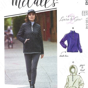 May include: Sewing pattern for a hooded sweatshirt with a zipper and an elastic hem. The pattern is from McCall's and is part of their Learn to Sew series. The pattern is for sizes XS, S, and M.
