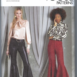 May include: Vogue Patterns sewing pattern R11913 for a blouse and flared pants. The pattern includes two views: a black leather pants with a white blouse and a red pants with a black and white striped blouse.