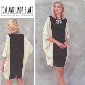 May include: A Vogue Patterns sewing pattern by Tom and Linda Platt, featuring a color-blocked dress design. The dress has a black center panel with cream-colored side panels and a boat neckline. The pattern includes sizes 6-14 and 16-22.