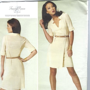May include: A Vogue Patterns sewing pattern by Tracy Reese. The pattern features a light yellow wrap dress with short sleeves and a matching belt. The model is wearing the dress with beige heels and a gold cuff bracelet. The pattern number is V1285.