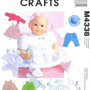 May include: McCall's Crafts sewing pattern M4338 for doll clothes. The pattern includes various outfits: dresses, tops, pants, a hat, and accessories. The doll in the image is wearing a white dress with a pink bow.