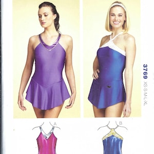 May include: A Kwik Sew 3769 sewing pattern envelope for misses' sizes XS-XL. The cover features two leotards with skirts: one purple with a V-neck and metallic trim, and one blue with a white halter neck. Includes technical sketches of both designs.