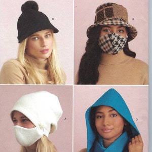 May include: A sewing pattern for four different styles of hats. The pattern is called Simplicity S9368 and includes instructions for a black beanie with a pompom, a plaid bucket hat, a white hooded hat, and a blue hooded hat.