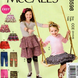May include: A sewing pattern for a girl's skirt and leggings. The pattern includes a variety of styles, including a tiered skirt, a ruffled skirt, and leggings with different designs. The pattern is for sizes 3-4-5-6. The pattern is called McCall's M6598.