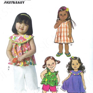May include: A sewing pattern for making four different outfits for a toddler. The pattern includes a floral print top and white pants, a green and white floral print top and pink shorts, a plaid dress, and a purple dress with a floral trim.