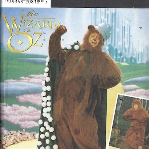 May include: A Simplicity sewing pattern envelope for a Wizard of Oz Cowardly Lion costume. The package features a brown faux fur jumpsuit, a matching hood with ears, a blue crown, and a dark green cape trimmed with white pom-poms.