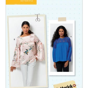 May include: Two women modeling different versions of a blouse pattern. The blouse on the left is pink with a floral print and the blouse on the right is blue with a lace trim. The pattern number is B6561.