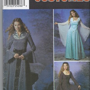 Peut inclure: Patron de costumes Simplicity avec des robes de style médiéval. La couverture présente trois modèles de robes différents dans des tons de bleu et de marron. Le patron comprend les tailles 6, 8, 10 et 12.