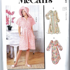 May include: A sewing pattern for a dress with multiple view options. The pattern includes a dress with short sleeves and a dress with long sleeves. The dress is printed with a floral pattern. The pattern is for sizes XS, S, and M.