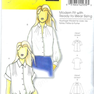 May include: Butterick B5365 sewing pattern for women's blouses. The illustration shows a white blouse with short sleeves and a pleated front, paired with gray plaid pants. Another version features long sleeves. The pattern includes sizing information.