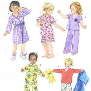May include: Simplicity sewing pattern number 3584 for children's pajamas. The pattern includes five different styles: a purple robe, a pink and white pajama set with butterflies, a purple pajama set with a flower, a yellow pajama set with a dog print, and a red and white pajama set with a bear print. The pattern is for sizes 1/2, 1, 2, 3, and 4.