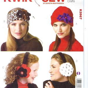May include: A sewing pattern featuring four winter accessories: a leopard print headband with flower embellishments, a red beanie with purple flowers, and two styles of earmuffs. The text "KWIK SEW" and "K3967 Crafts" are visible.
