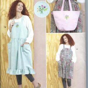 May include: A sewing pattern for two different styles of dresses with pockets and a tote bag. The dresses are both knee-length and have a gathered skirt. The tote bag has a simple design with a single pocket. The pattern is from Simplicity and is easy to sew.