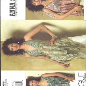 May include: Vogue Anna Sui pattern V2968. The image shows three different styles of a top or dress. The designs feature a V-neck and various patterns, including floral and paisley. The pattern size is DD (12-14-16-18).