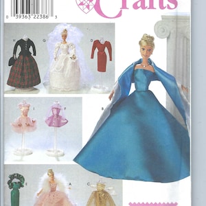 May include: Simplicity Crafts pattern 8481 featuring doll clothes designs. The cover shows various doll outfits, including a wedding dress, ball gowns, and other dresses. The pattern includes the text "ONE SIZE" and "UNE SEULE TAILLE".