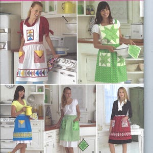 May include: A sewing pattern for four different aprons. The pattern is from Simplicity and is for sizes S, M, and L. The aprons are all different colors and patterns. The pattern is called "Kimberly Einmo" and is by Wrights Quilting.
