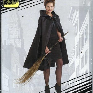 May include: Simplicity pattern W0224 for super easy capes. The image shows a woman wearing a black cape with a hood, holding a broom. The pattern is one size and designed and printed in the USA.