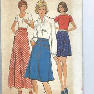 May include: A vintage sewing pattern for three skirts. The pattern is for sizes 24 to 30 waist and 33 1/2 to 40 hip. The skirts are shown in red and white gingham, blue denim, and blue floral print.