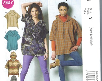 May include: Sewing pattern McCall's M6603 for size Y (Xsm-Sml-Med) featuring five different styles of tops with a hooded option. The pattern includes a brown and white plaid top, a purple top with a V-neck, a teal blue top with a cowl neck, a beige top with a turtleneck, and a gray hooded top.