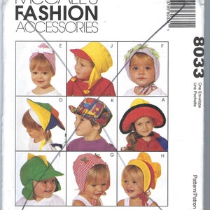 May include: McCall's Fashion Accessories pattern featuring various children's hats. The hats include a pink bow, a yellow and red sun hat, a colorful patchwork cap, and a green dinosaur-themed hat. Sizes fit infant and children's heads 19 1/2 to 22 inches.