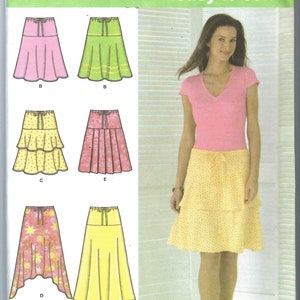 May include: A sewing pattern for a skirt with different styles. The pattern includes a pink, green, yellow, and floral print skirt. The pattern is for sizes 16, 18, 20, and 22. The pattern is from Simplicity and is easy to sew.