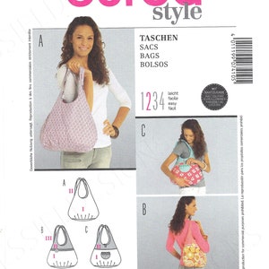 May include: Burda Style sewing pattern number 7410 for bags. The pattern includes instructions for making three different styles of bags: a tote bag, a shoulder bag, and a crossbody bag. The pattern is printed on white paper with black ink. The pattern includes seam allowances.