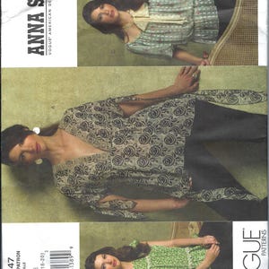 May include: A sewing pattern for a blouse with three different styles. The pattern is from Vogue Patterns and designed by Anna Sui. The pattern number is V2947 and the sizes are 14-16-18-20.