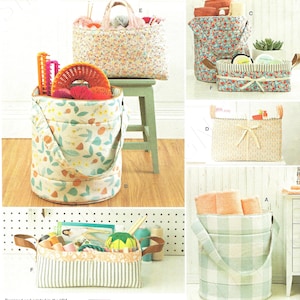 May include: Simplicity sewing pattern showing fabric storage baskets in various designs. The baskets are displayed in different sizes and shapes, with floral, striped, and checked patterns. Some have handles, and others have lids. The pattern includes the text "U.S. ONE SIZE".