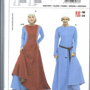 May include: A Burda 7977 sewing pattern envelope for a historical dress. The cover displays two variations: a long-sleeved blue dress with a rust-colored over-tunic and a crown, and a long-sleeved blue dress with a white headpiece and a dark brown belt.