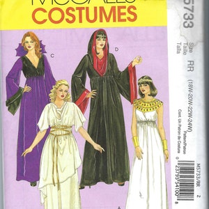 May include: McCall's Costumes pattern M5733 showing four costume designs: a hooded robe, a vampire dress, a Grecian-style gown, and an Egyptian-inspired dress. The pattern includes size RR (18W-20W-22W-24W).